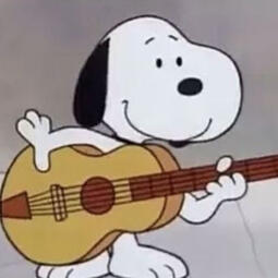 Snoopy the cartoon dog with a brown guitar